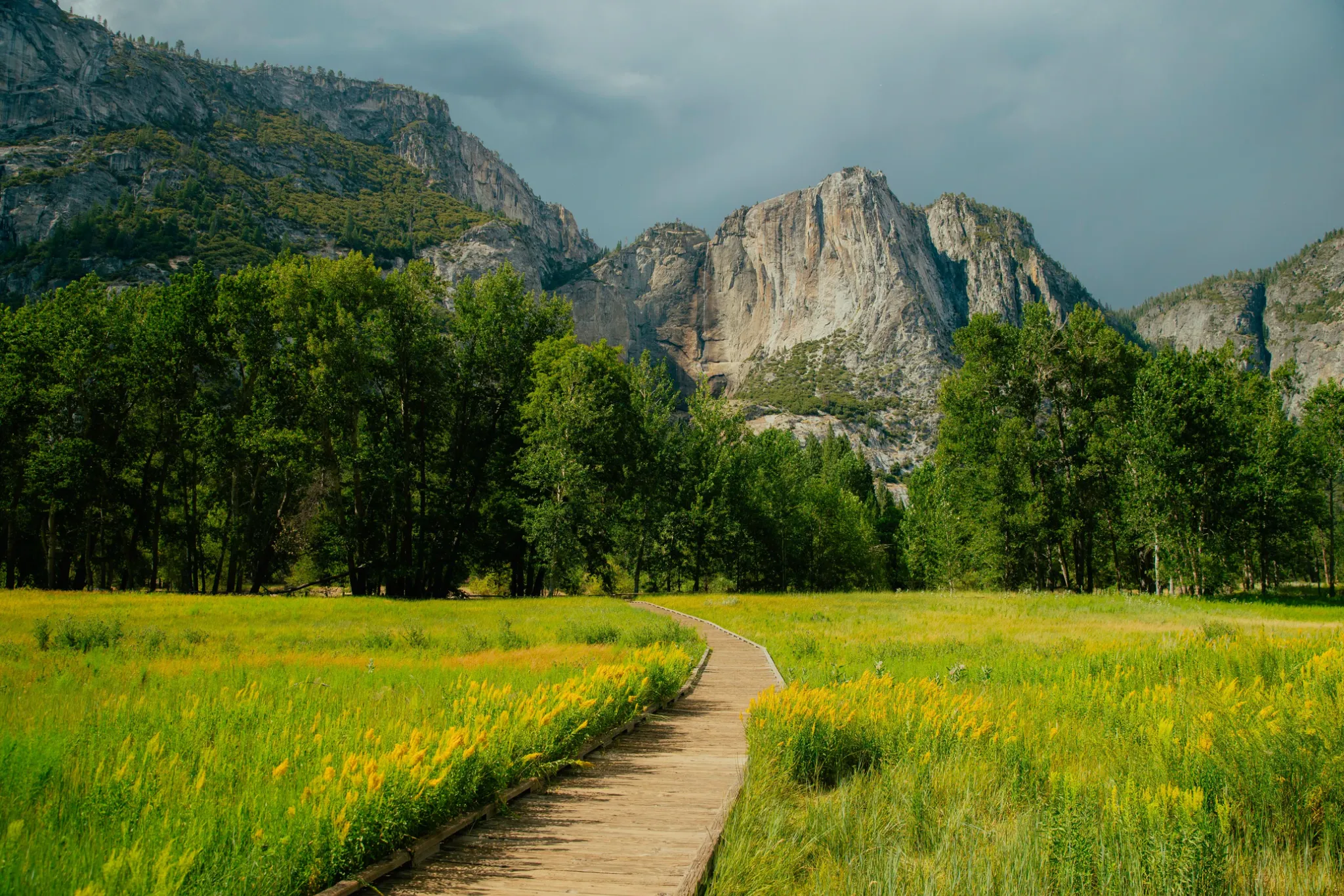 A boardwalk leading toward a mountain pass